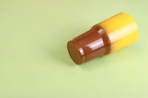 Macro view of 30oz stainless steel vacuum tumbler with brown and yellow gradient finish