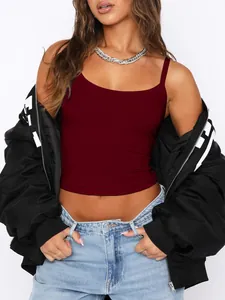 Stylized dark red Y2K camisole crop top layered with a black jacket and denim jeans