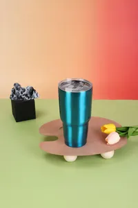 30oz teal stainless steel insulated car tumbler on artistic wooden palette stand