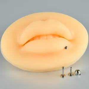 Close-up of G23 titanium internal thread lip stud on silicone practice model