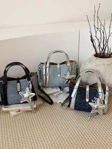 Stylish commuter crossbody bucket bags in textured fabric with decorative star charms