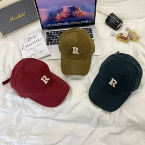 Three stylish brushed canvas baseball caps with 'R' embroidery in various autumn colors