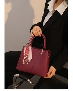 Elegant red leather handbag with stylish scarf detail, large capacity shoulder bag.