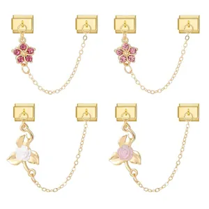 Detail view of four gold Italian charm links with floral pendants and dangling chains