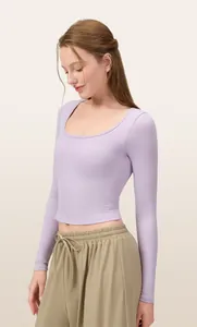 Slim-fit lilac long-sleeved yoga top with U-neckline, worn by model on neutral background