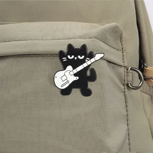 Cool black cat enamel pin playing a white guitar pinned on olive green fabric backpack