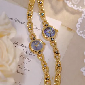 Reloj vintage dorado para mujer con esfera de nácar púrpura y elegante brazalete de eslabones