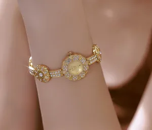 Elegant vintage gold floral bracelet watch with sparkling rhinestone embellishments on a wrist