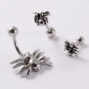 Detalle de conjunto de piercings para ombligo y oreja en acero inoxidable con arañas