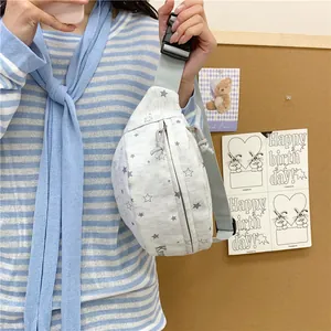 Detailed side view of a grey canvas waist pack with star patterns worn on a person