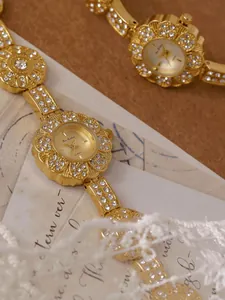 Elegant macro detail of a vintage gold floral bracelet watch decorated with shiny rhinestones