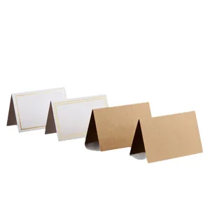 Elegant white wedding place cards with gold foil border and rustic kraft paper tent cards