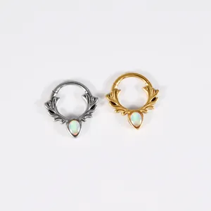 Close-up of antler-style stainless steel septum rings with teardrop opal inlays