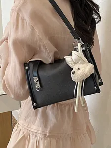 Casual black pillow shoulder bag for women with cute teddy bear charm detail