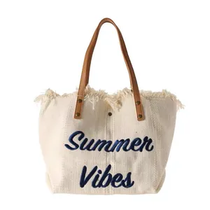 Large white canvas tote bag with navy Summer Vibes embroidery and fringe trim for beach use
