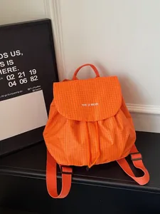 Stylish orange checkered small backpack for women, perfect for daily commute and casual use.