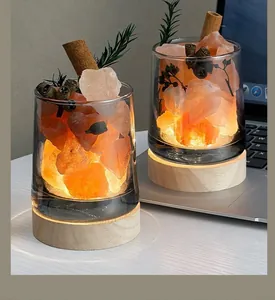 Decorative warm orange salt crystal aromatherapy night light with a natural wooden base