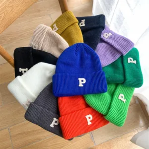 Collection of vibrant colorful knitted beanies featuring white letter P embroidery detail