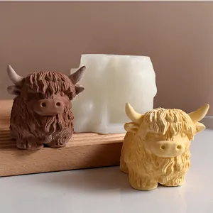 Close-up of textured highland cow resin figurines and silicone mold for DIY home decor