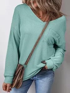 Detailed view of mint green V-neck ribbed pullover sweater with chest pocket detail