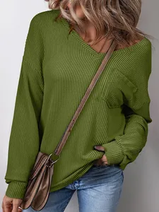 Detailed view of olive green waffle knit pullover featuring V-neck and pocket