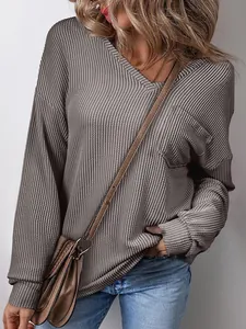 Close-up of women's casual grey waffle-knit V-neck pullover sweatshirt with chest pocket detail