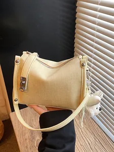 Stylish beige textured pillow handbag for women with cute plush charm