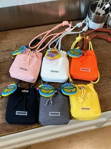 Fashionable mini mesh bucket bags with drawstring and chunky rope straps in various colors.
