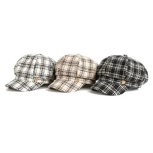 Three classic plaid newsboy caps with heart-shaped metal buttons in different colors