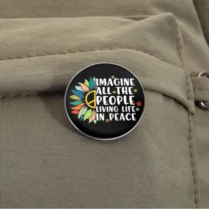 Macro detail view of an Imagine Peace sunflower brooch pinned on a khaki canvas bag