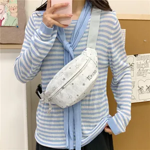 Detail showing a white chest bag with star pattern worn by a model in casual style.