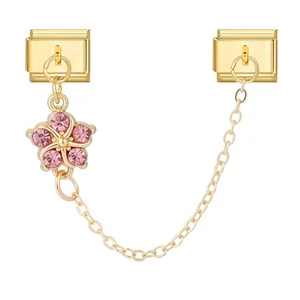 Detailed macro view of gold Italian modular charm featuring a pink rhinestone flower
