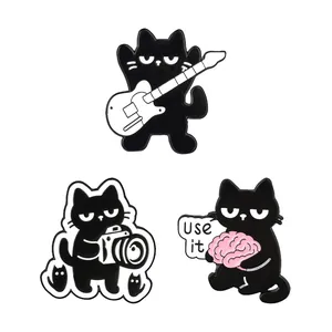 Cartoon black cat enamel pins set featuring guitar, camera, and brain slogan designs.