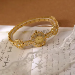 Elegant gold flower bracelet watch with shiny rhinestones for a vintage aesthetic