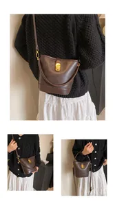 Vintage dark brown bucket bag shown on model with black cardigan and white skirt