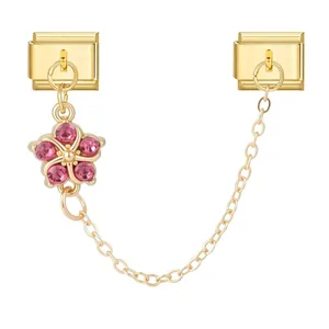 Detailed view of golden Italian charm module with pink rhinestone flower and chain connection