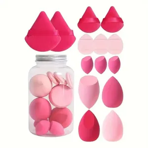 Set of various pink makeup sponges and powder puffs displayed with a clear storage jar