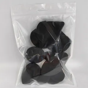 Detailed view of black makeup sponges and puffs set in a transparent plastic bag