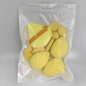 Detailed view of yellow makeup sponges and puffs inside clear plastic zip-lock packaging