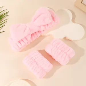 Soft pink plush bow headband and matching wrist washbands set for skincare routine