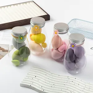 Detailed view of colorful soft makeup sponges in decorative clear jars with daisy lids