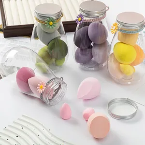 Detail view of colorful makeup blender sponges set in decorative transparent storage jars
