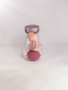 Elegant decorative glass jar filled with soft multi-toned pink makeup beauty sponges