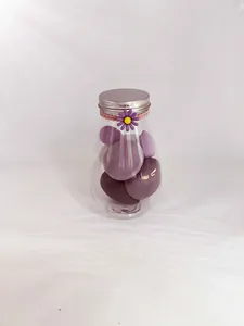 Detailed macro view of soft purple makeup sponges stored in a clear bulb-shaped decorative jar