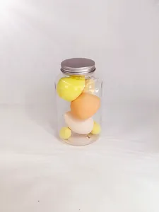 Detail showing a transparent jar filled with assorted color makeup sponges