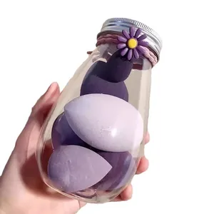 Set of soft purple makeup sponges in a decorative glass jar