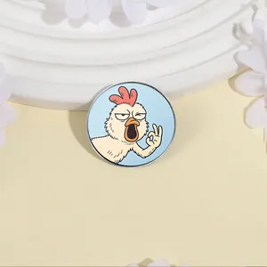 Detail of a funny hand-drawn chicken enamel pin with OK gesture and shouting expression.