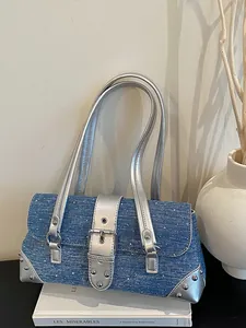 Stylish denim baguette shoulder bag with silver leather straps and decorative metal studs