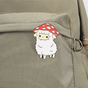 Detailopname van een schattige paddenstoel schaap emaille speld op een groene canvas rugzak