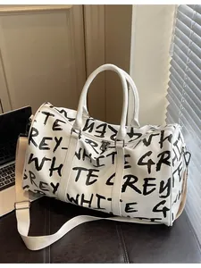 Large capacity travel duffel bag with black graffiti letters on durable white leather.